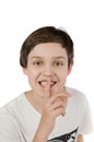 Boy finger on mouth and smiling Royalty Free Stock Photo